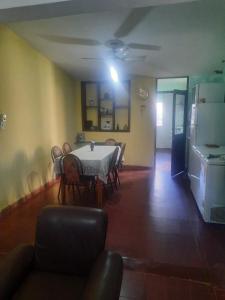 a dining room with a table and chairs and a refrigerator at Casa Alojamiento TELAR DE SUEÑOS in Belén