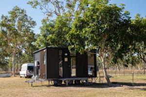 a tiny house is parked next to a tree at Mountview Getaway by Tiny Away in Toonpan