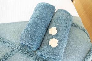 two blue towels with two white buttons on them at Mountview Getaway by Tiny Away in Toonpan