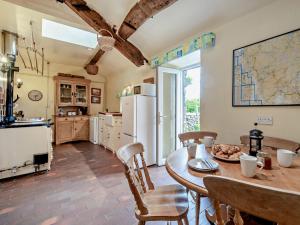 a kitchen and dining room with a table and chairs at 3 Bed in Eskdale 94529 in Eskdale