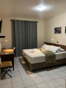 Ένα ή περισσότερα κρεβάτια σε δωμάτιο στο Hotel Concord e Eventos corporativos Campo Grande