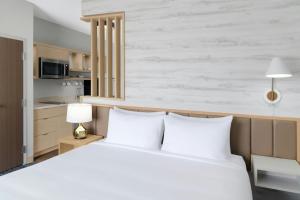 a bedroom with a white bed with two white pillows at TownePlace Suites by Marriott Columbus in Columbus +33 photos
