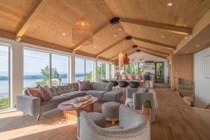 a living room with a couch and chairs at La Bergerie in Saint-Joseph-de-la-Rive