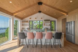 a kitchen with a large island with bar stools at La Bergerie in Saint-Joseph-de-la-Rive
