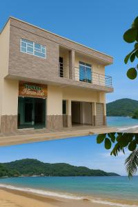 a house on the beach and a picture of it at Habitaciones con wifi a 5 minutos de la playa in Capurganá +75 photos