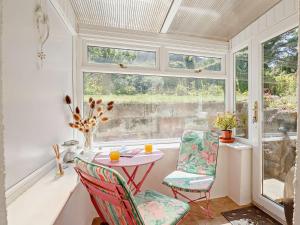 a room with a table and two chairs and a window at 1 Bed in Conwy 92421 in Penmaen-mawr +12 photos