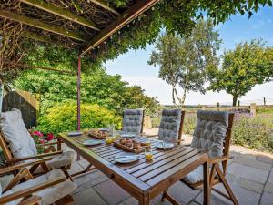a wooden table and chairs on a patio at 3 Bed in Faceby 95424 in Whorlton