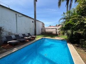a swimming pool with lounge chairs and a swimming pool at Casa Gabriela in Bucerías