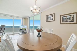a dining room with a table and views of the ocean at Perdido Sun Unit 914 in Pensacola