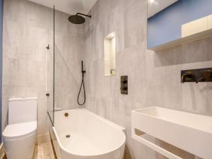 a white bathroom with a toilet and a sink at 2 Bed in Evesham 88722 in Bretforton