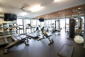 a gym with several treadmills and cardio machines at 2 Luxe 2BR Apts Near Big House w Parking & Gym in Ann Arbor