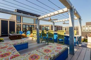 a patio with a table and chairs on a deck at 2 Apts w King Beds - Near Kerrytown in Ann Arbor