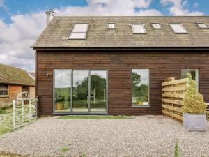 a house with large windows on the side of it at 2 Bed in Sturminster Newton 88265 in Fiddleford