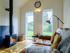a living room with a couch and a fireplace at 1 Bed in Talybont-on-Usk 88137 in Talybont