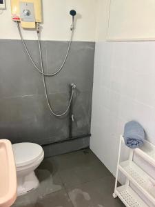 a bathroom with a shower with a toilet and a sink at Bali Style Rooftop Apartment in Bangkok +23 photos