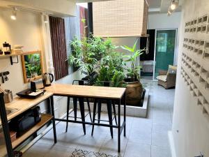 a kitchen with a table and some potted plants at Bali Style Rooftop Apartment in Bangkok