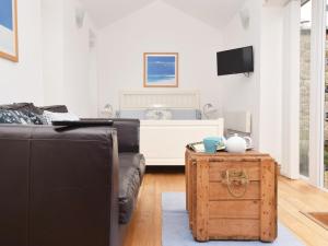 a living room with a couch and a table at 1 Bed in Nr Bamburgh CN002 in Lucker