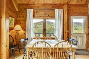 a dining room with a table and chairs and a window at Perry Hill Escape in Waterbury