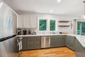 a kitchen with gray cabinets and a stainless steel refrigerator at Topnotch 384D in Stowe Fork