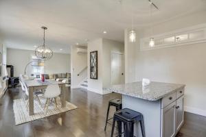 a kitchen and living room with a counter and a table at Scharkie Ski Haus in Stowe