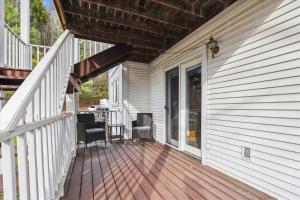 a front porch of a house with a wooden deck at River's Edge 308 in Stowe