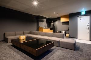 a living room with a couch and a coffee table at 廣島別邸 デラックススイート Hiroshima Villa for 10ppl - Supported by COCOSTAY in Hiroshima