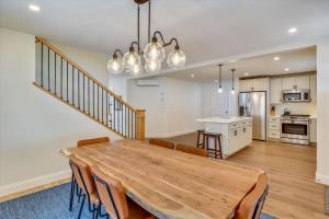 a kitchen and dining room with a wooden table and chairs at Village with a View in Stowe +21 photos