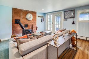 a living room with a couch and a fireplace at Mountain Haus in Stowe Fork