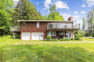 a house with a large yard in front of it at Mountain Haus in Stowe Fork