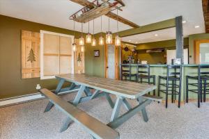 a picnic table in a kitchen with a bar at Mountain Haus in Stowe Fork +24 photos
