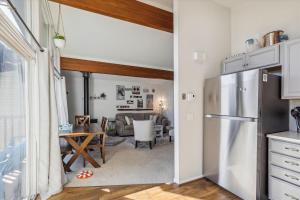 a kitchen with a refrigerator and a dining room at Mountainview Condo #2 in Stowe +24 photos