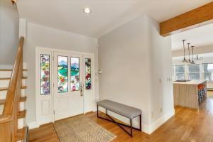 a living room with a bench in front of a door at The Eagle's Nest at Stowe in Stowe