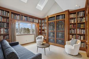a living room filled with book shelves filled with books at Stowe Haven in Stowe