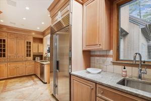 a kitchen with wooden cabinets and a stainless steel refrigerator at Stowe Haven in Stowe