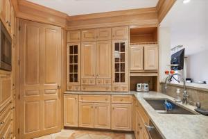 a kitchen with wooden cabinets and a sink at Stowe Haven in Stowe +37 photos