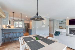 a kitchen and a living room with a dining room table at Village Sunrise in Stowe