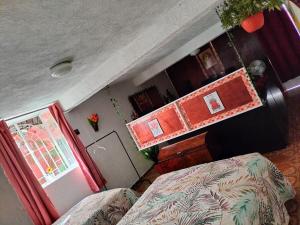 a small room with a bed and a window at Quiet and beautiful apartment in Orizaba