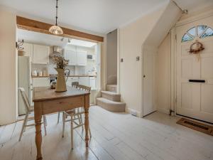 a kitchen and dining room with a table and chairs at Greenfield Cottage 1866 in Broadwater