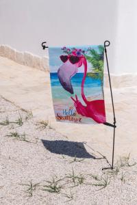 a painting of a pink flamingo on the beach at Trullo Flamingo - Luxury Villa with private pool in Serranova
