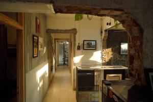 a hallway of a kitchen with an archway at KOTTA Hostel in Timuran