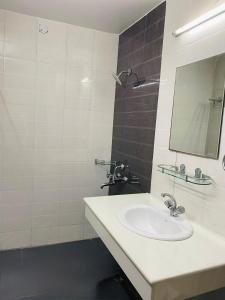 a bathroom with a sink and a mirror at The Alpine Ramgarh in Rāmgarh +58 photos