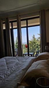 a bedroom with a bed and a large window at The Alpine Ramgarh in Rāmgarh