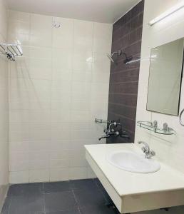 a bathroom with a sink and a mirror at The Alpine Ramgarh in Rāmgarh