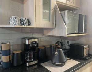 a kitchen counter with a coffee maker and a coffeemaker at Hantam Suites in Centurion