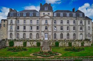 a large castle with a garden in front of it at Roulotte la comtesse gitane in Plescop +16 photos