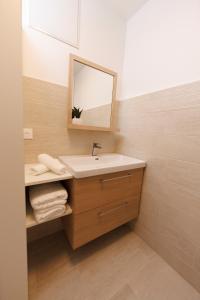 a bathroom with a sink and a mirror at Le 7 KLÉBER in Colmar +11 photos