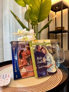 two books sitting on a table with a remote control at Cebu Minimalism 1 Bedroom in Cebu City