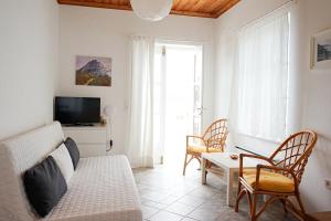a living room with a couch and a table at Kiki's Houses Vlichos in Hydra