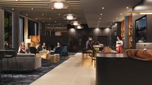 a lobby of a hotel with people sitting at tables at Hyatt Place Whitehorse in Whitehorse