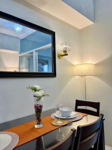 a dining room table with a mirror on the wall at Cebu Minimalism 1 Bedroom in Cebu City